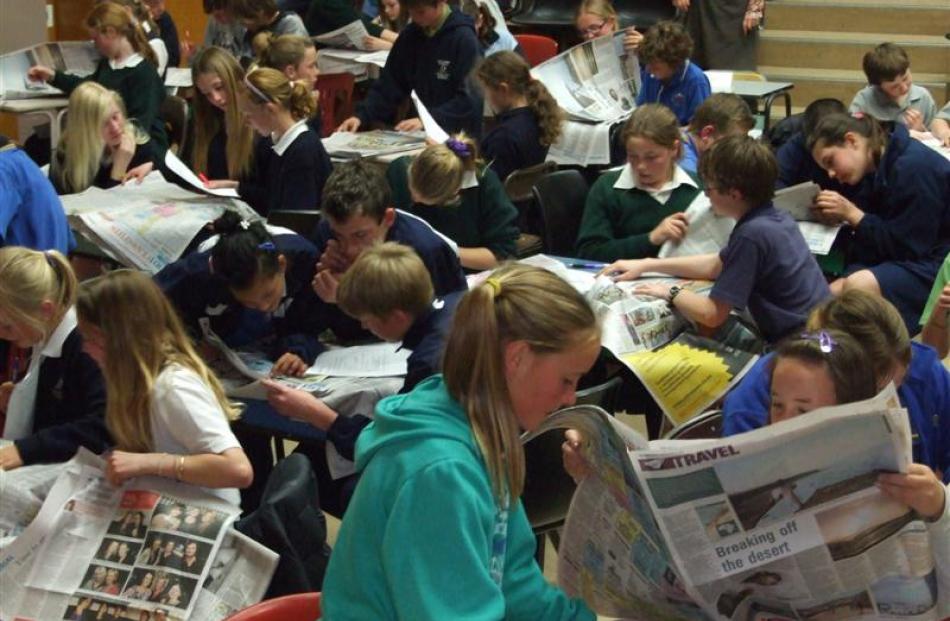 Year 7 and 8 pupils "scavenge" through the newspaper for answers. Photos by Lynda van Kempen.