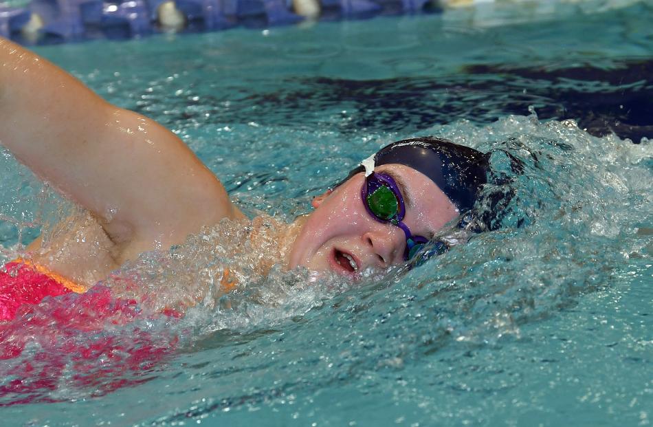 Taking a breath as she freestyles through the water.