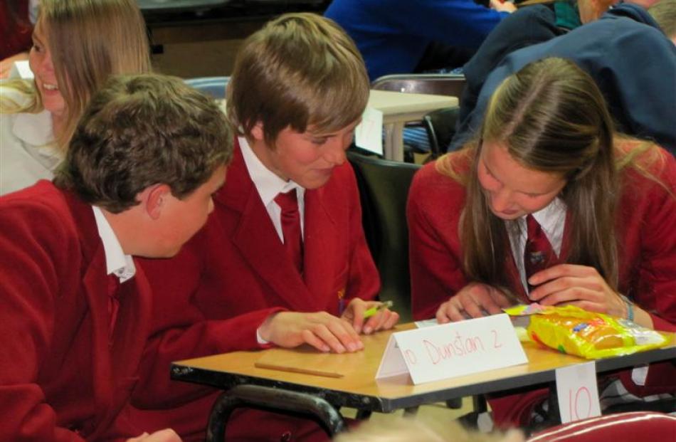 Dunstan High School pupils Tain Laing (13), Jack Paulin (14) and Adriana Mawhinney (14) check...