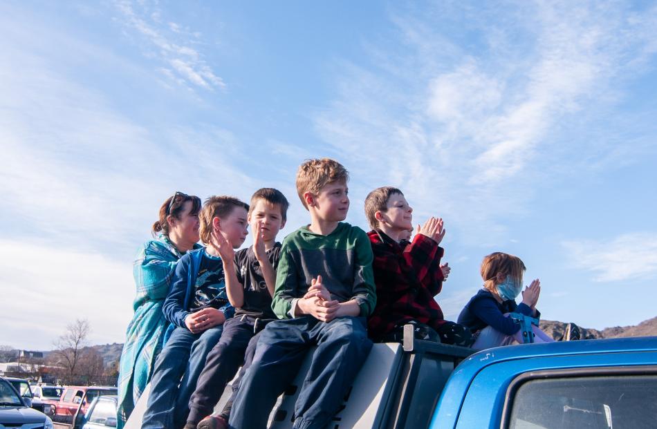 Using their ute as a vantage point, Poolburn woman Amy Nicholson and her children (from left)...
