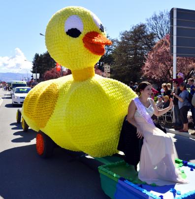 Rikki-Lee McLean waves from the Stadium Tavern Social Club's Wobbly Ducks float.