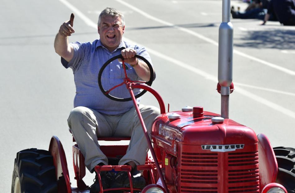 Alan McCrostie, of Alexandra, drives his vintage Farmall tractor in the Grand Parade.