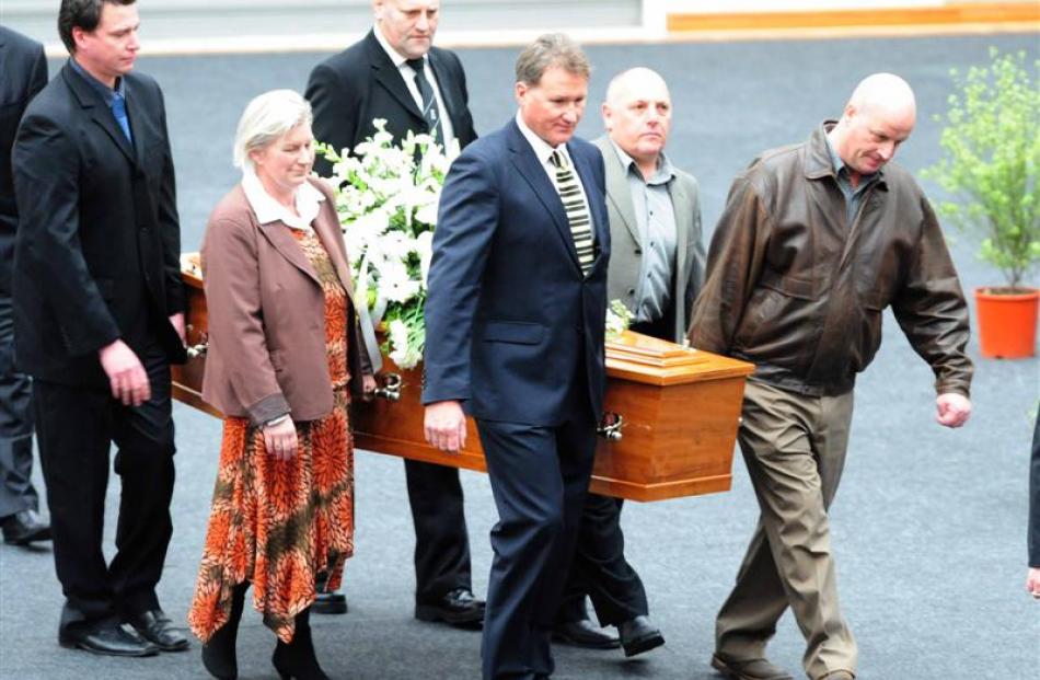 Pallbearers, including Olympian Danyon Loader, carry Laing's coffin. Photo by Craig Baxter.
