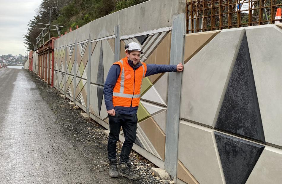NZ Transport Agency senior project manager Jason Forbes admires the taniwha wall mural, designed...