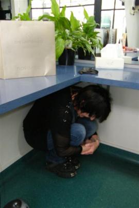 Former Christchurch resident Leigh Baughan takes cover in her Oamaru hairdressing salon, Kut...
