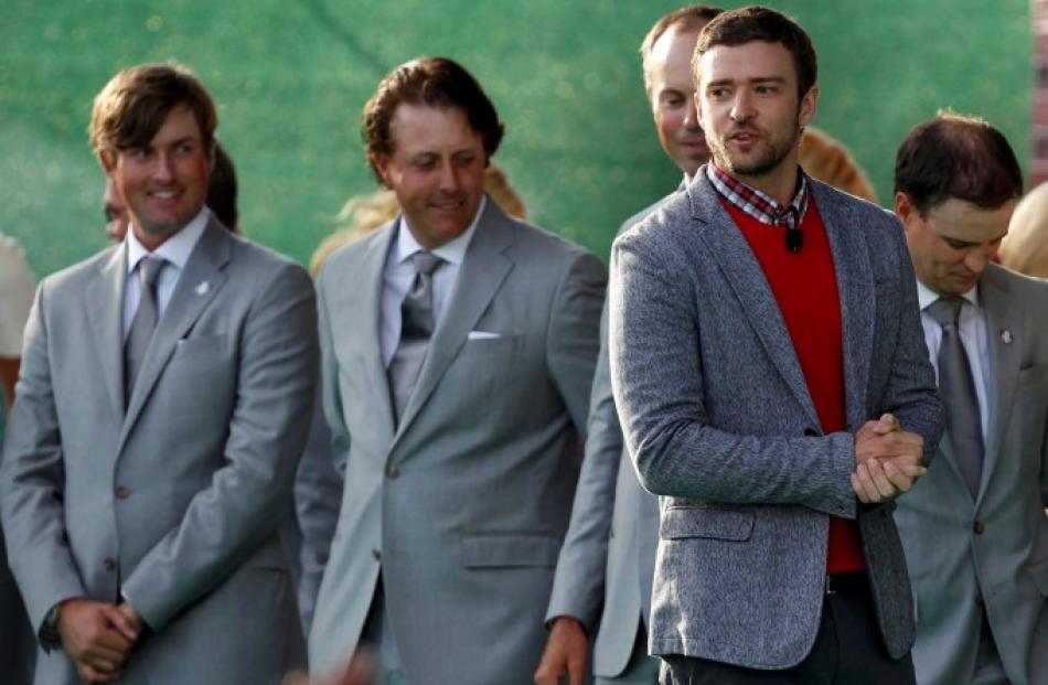 Justin Timberlake (R) stands next to US golfers Webb Simpson (L) and Phil Mickelson (C) as he...