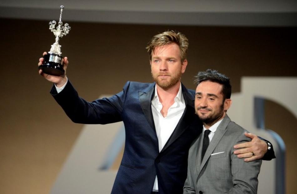 Scottish actor Ewan McGregor (L) hold up his Donostia Award For Lifetime Achievement presented to...