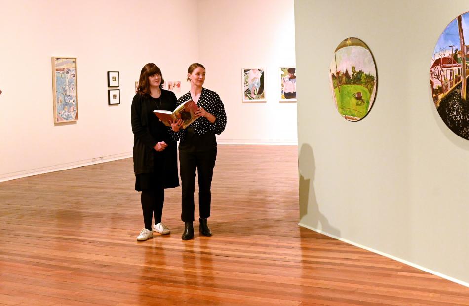 Curators Lauren Gutsell (left) and Lucy Hammonds prepare for the upcoming ‘‘Joanna Margaret Paul:...