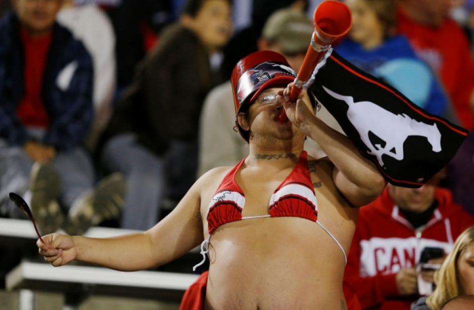 A Calgary Stampeders fan cheers for his team during the second half of their CFL football game...