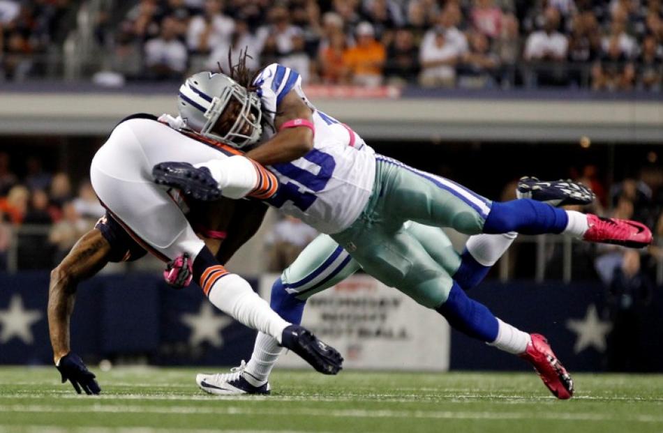 Chicago Bears wide receiver Brandon Marshall is tackled by Dallas Cowboys safety Danny McCray in...