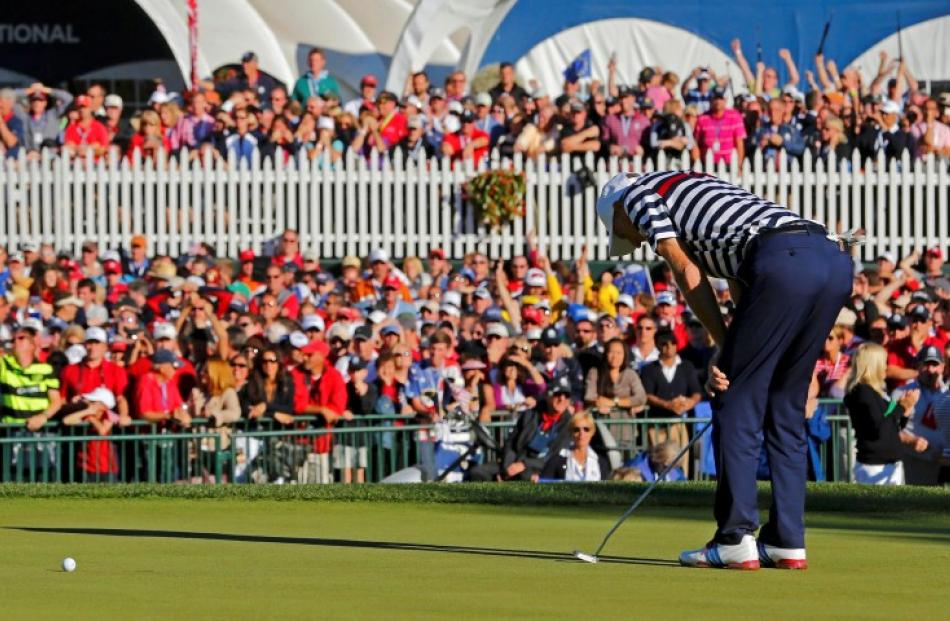 US golfer Jim Furyk reacts to missing a par putt on the 18th green to lose his match to Team...