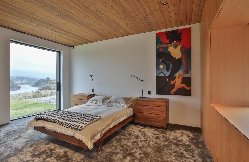 Bedroom windows frame views of the Shotover River.

