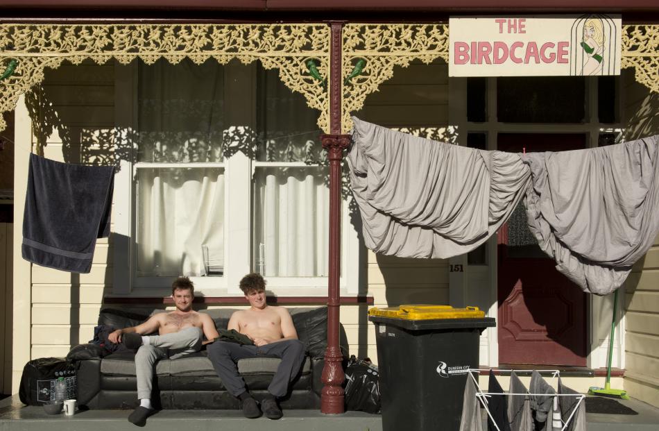 Catching some sunlight alongside their drying washing yesterday are Dunedin students Ashton...