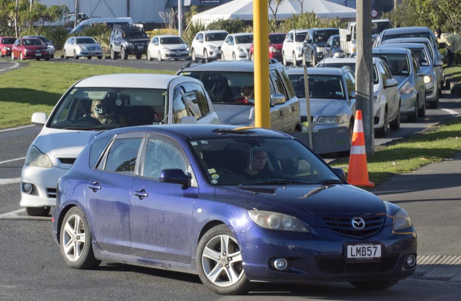 Cars back along Wharf St for the second day of the Te Kaika pop-up drive-through vaccination...