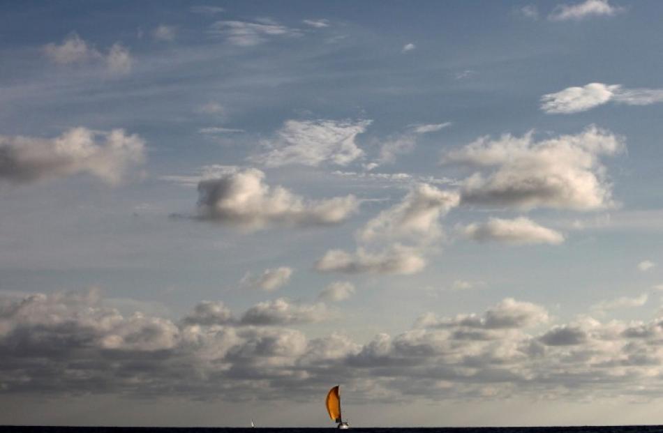 A sailboat competes at the fourth stage of the New Moon Regatta tournament off the coast of...