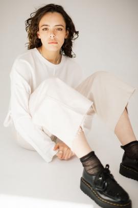 Monochromatic style is featured in Company of Strangers’ Base Sweater in White. Ease is exuded in...