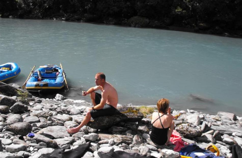 Rafting instructor Roger Leigh and camper Brenda Gray enjoy hokey pokey ice creams delivered by...