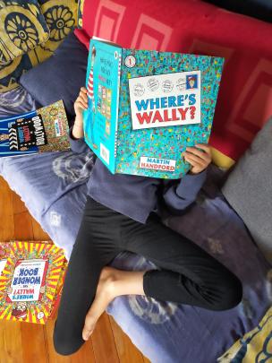 Emma Bristow (9) gets lost in Where’s Wally books during lockdown. PHOTO: SUPPLIED