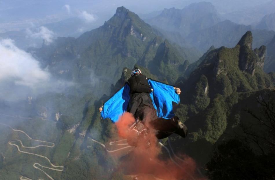A contestant flies during a World Wingsuit Championship at Tianmen Mountain in Hunan province,...