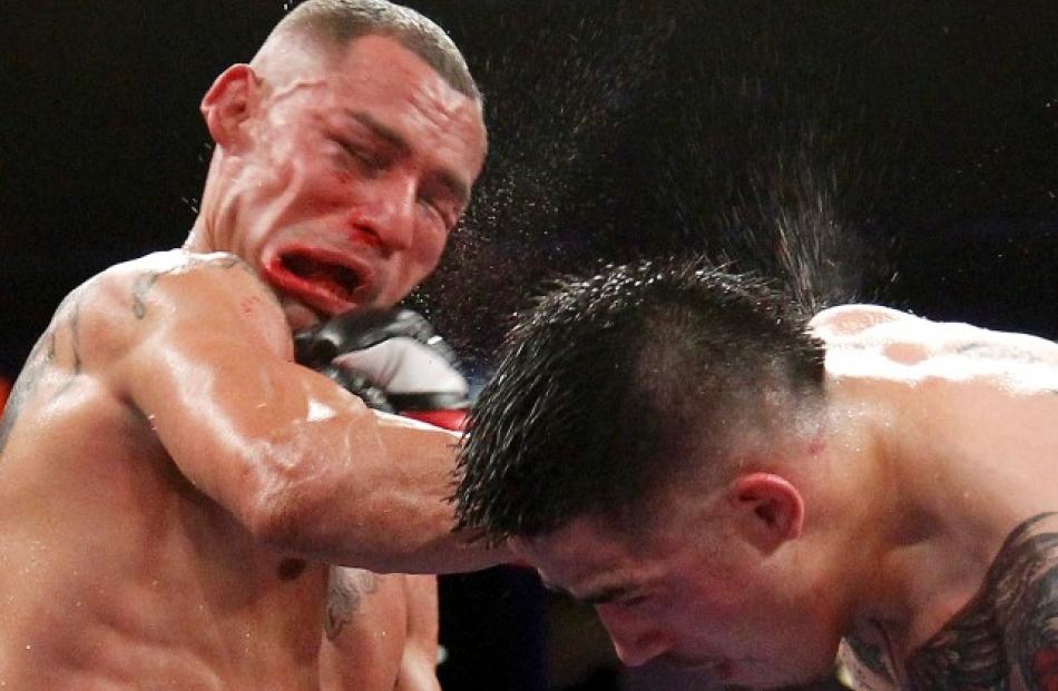 Brandon Rios (R) of the US connects with a punch to compatriot Mike Alvarado during their WBO...