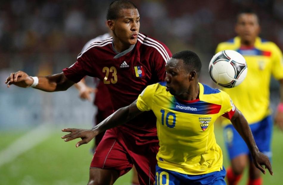 Ecuador's Walter Ayovi (R) and Venezuela's Jose Rondon challenge for the ball during their 2014...