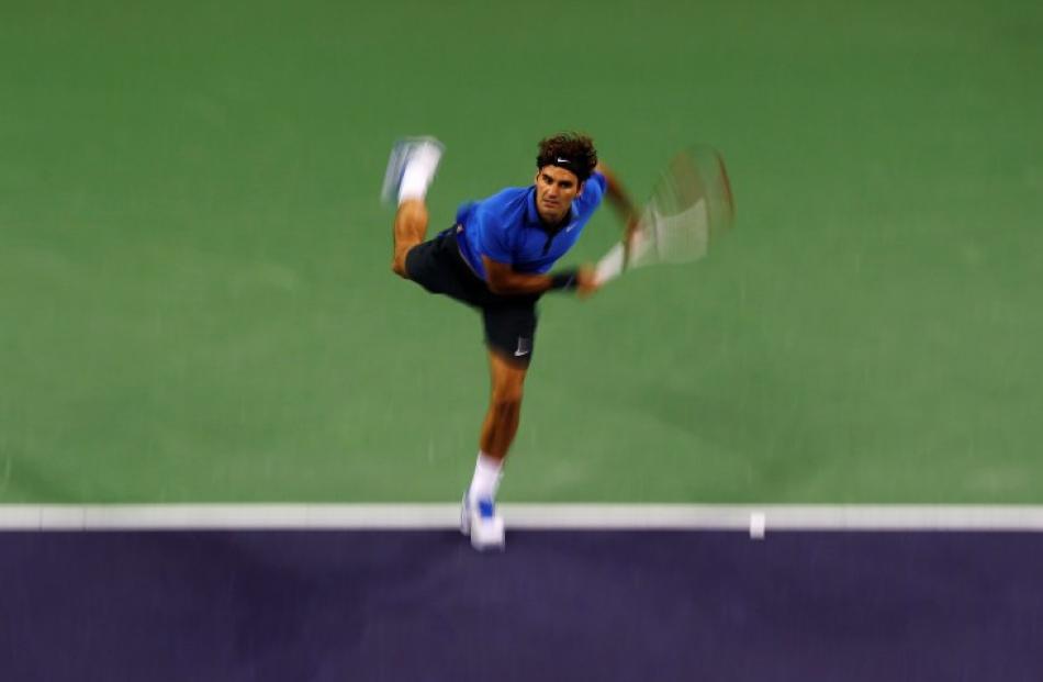 Roger Federer of Switzerland serves to Andy Murray of Britain during their men's singles...