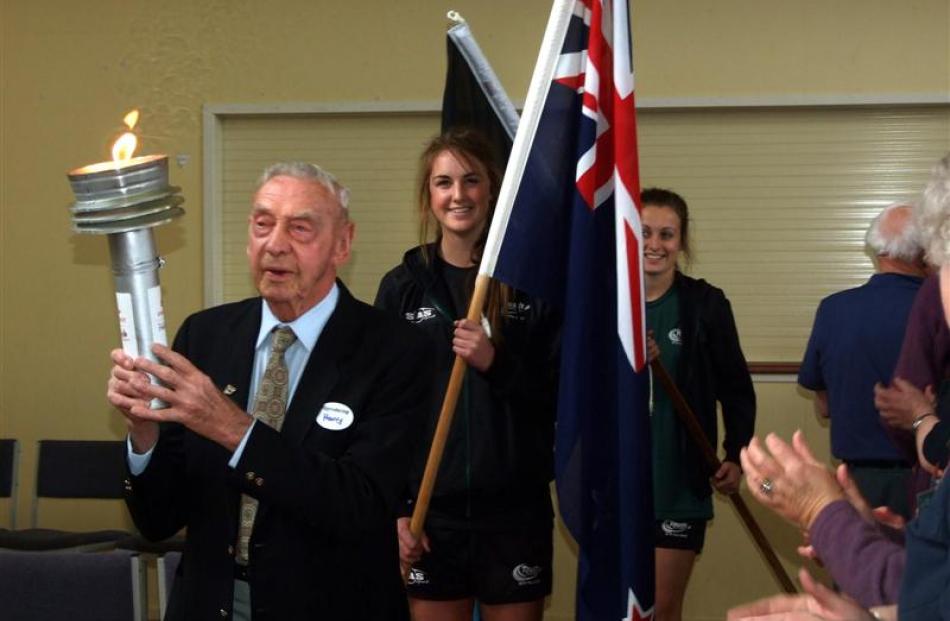 Torch-bearer Harry Peggie leads the opening parade, closely followed by South Otago High School...