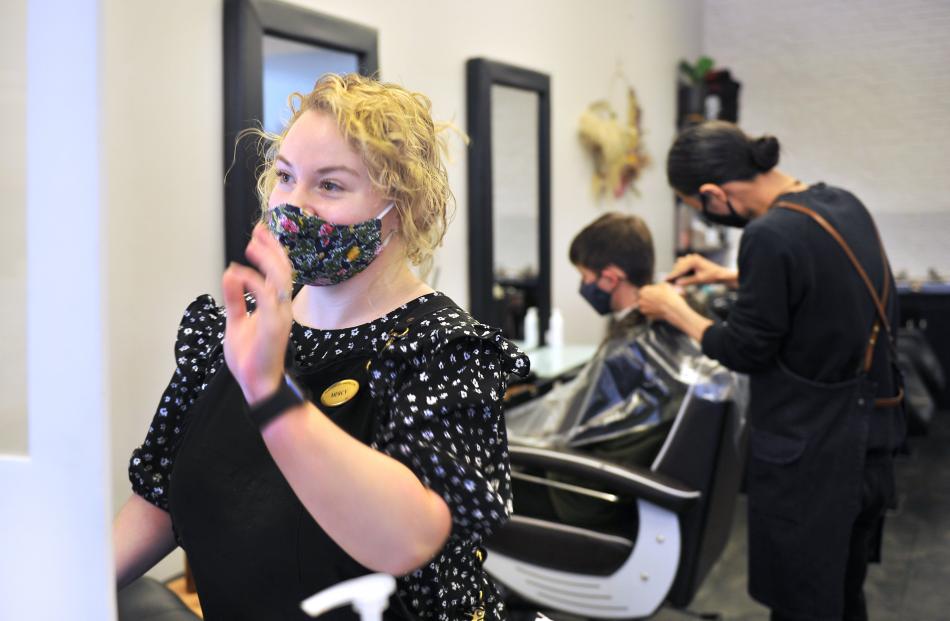 Hairdresser Mercy Barrett farewells a client at the Headquarters salon on George St yesterday...