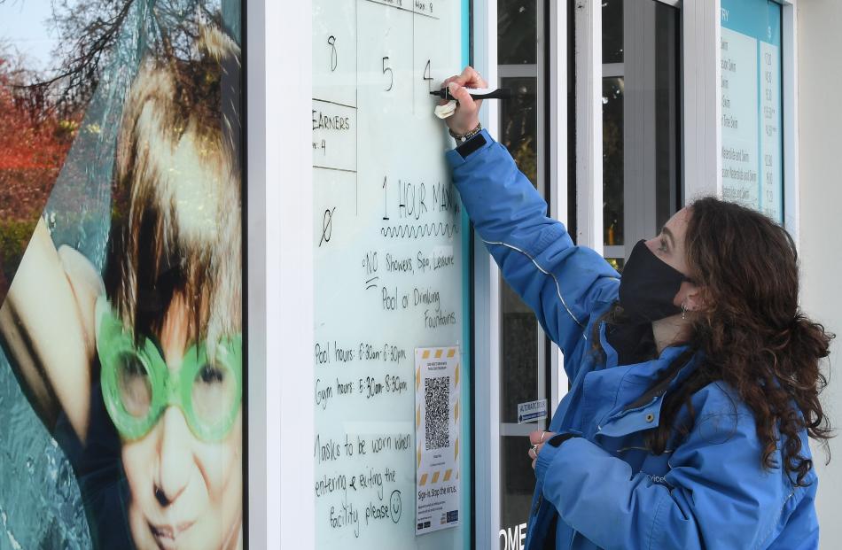 Moana Pool receptionist Marie Smith counts people in and out of the Dunedin facility yesterday....