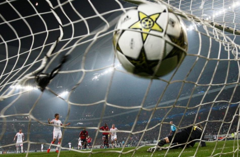 Bayern Munich's Thomas Muller (2nd L) scores a penalty against Lille during their Champion's...