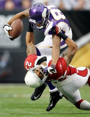 Minnesota Vikings receiver Jerome Simpson (81) is tackled by Arizona Cardinals Jamell Fleming (23...
