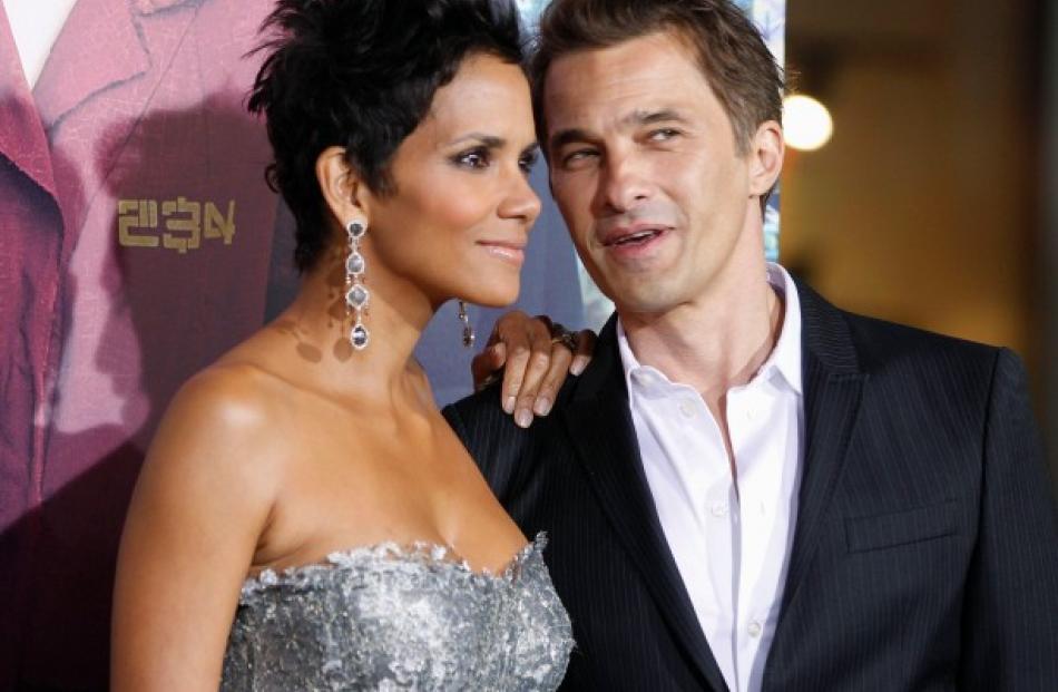 Actress Halle Berry poses as she arrives with her fiance, French actor Olivier Martinez, at the...