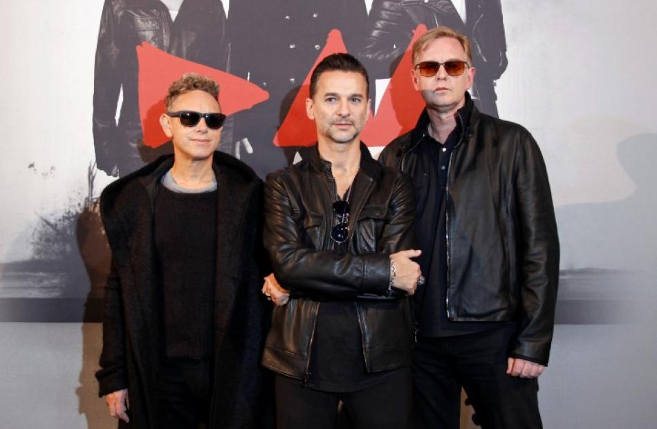 Depeche Mode members (L-R) Martin Gore, Dave Gahan and Andrew Fletcher pose during a photocall...