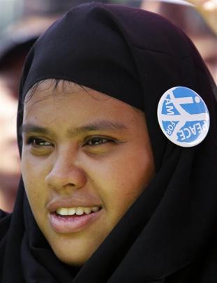 A woman shows her support for a peace deal during a vigil