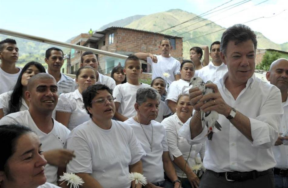 Columbia's President Juan Manuel Santos (holding a pigeon) whose Government seeks peace with Farc...