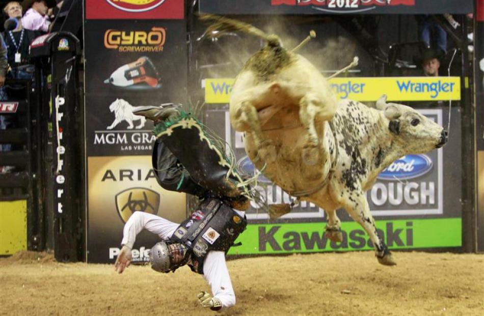Jordan Hupp of the US gets thrown off a bull during the Built Ford Tough Series Professional Bull...