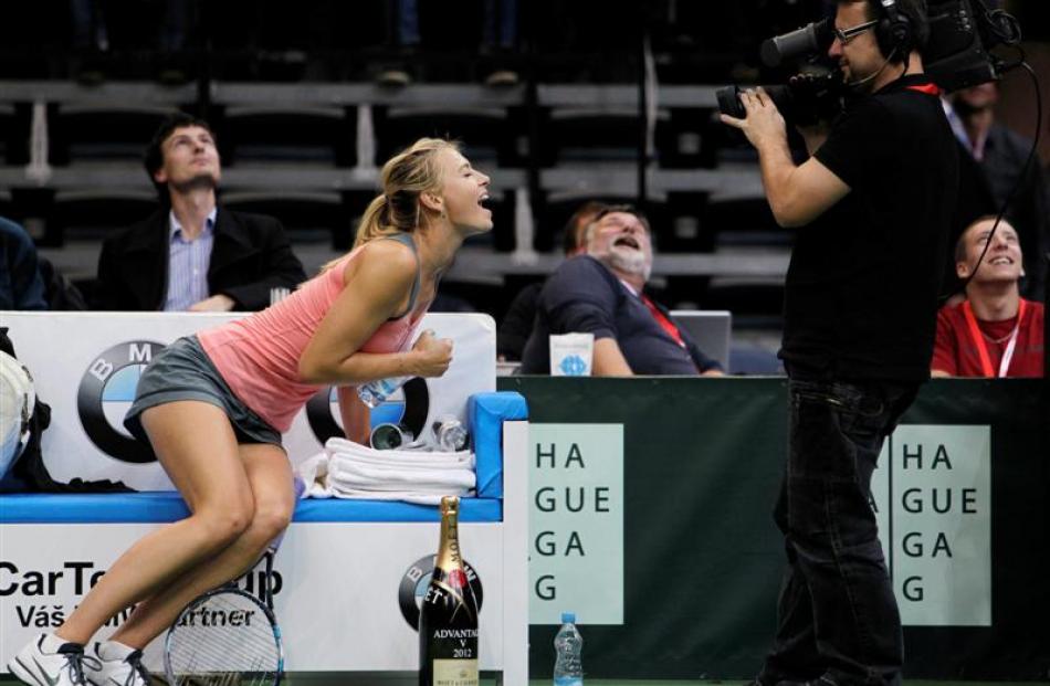 Russia's Maria Sharapova reacts to a television camera during an exhibition tennis match against...