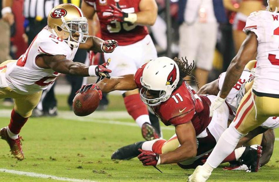 Arizona Cardinals Larry Fitzgerald is denied a last second touchdown by the San Francisco 49ers...