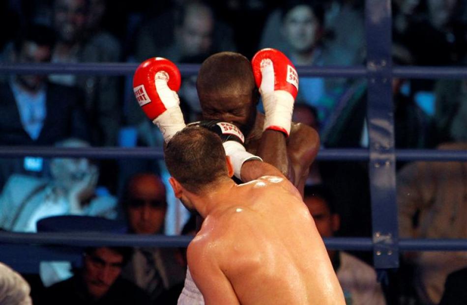 Afghan World Boxing Union champion Hamid Rahimi punches Said Mbelwa of Tanzania on his way to...