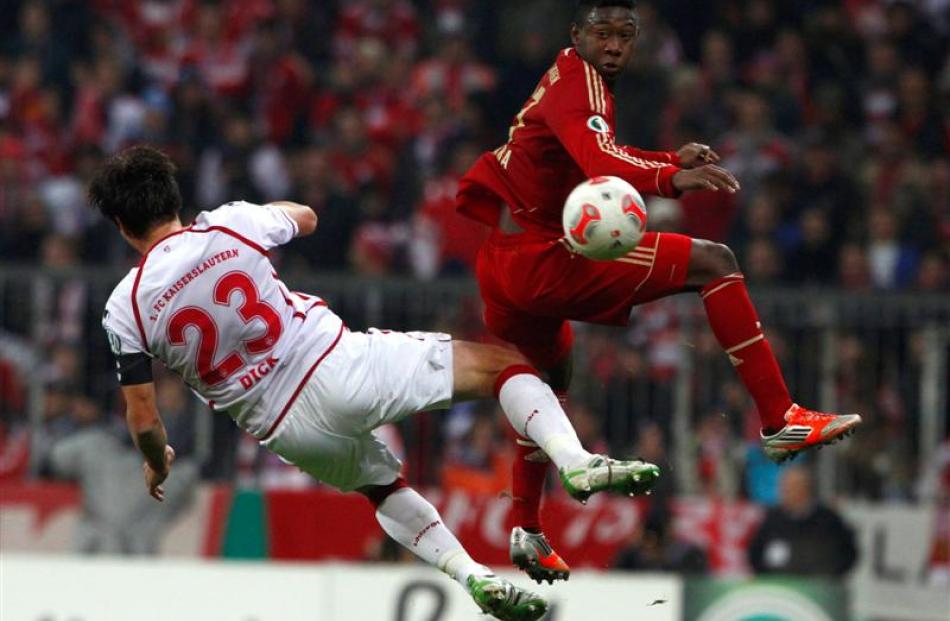 Bayern Munich's David Alaba fights for the ball with FC Kaiserslautern's Florian Dick. REUTERS...