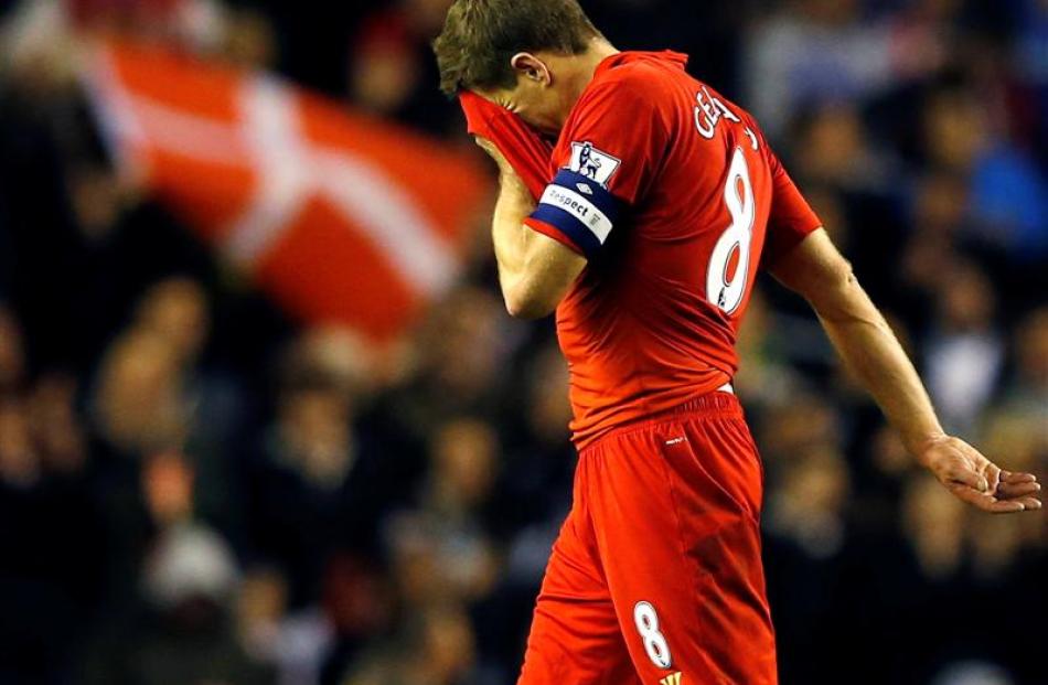 Liverpool's Steven Gerrard leaves the pitch after losing to Swansea in their English League Cup...