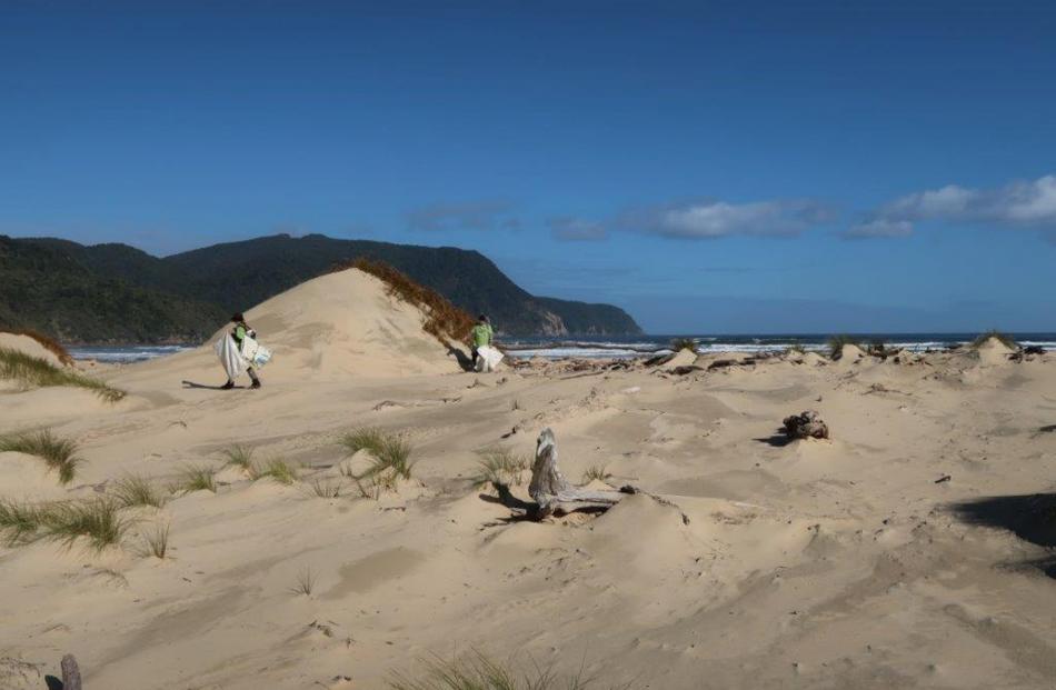 Volunteers collect rubbish at Stewart Island’s Mason Bay last week.