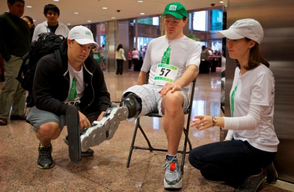 Research scientists Levi Hargrove (L) and Annie Simon watch as Vawter tests the leg before...
