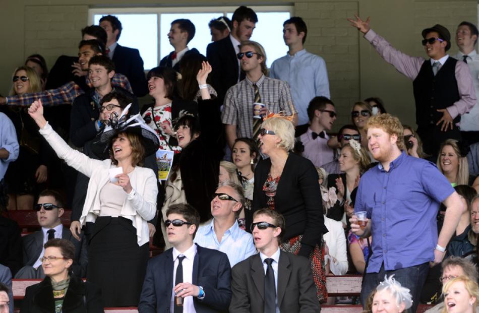 At left, Jenny Lambert of Mosgiel raises her hand in celebration.