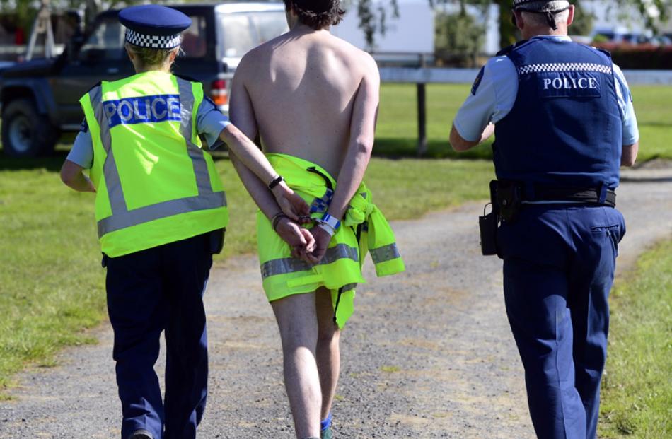 The streaker is arrested. Photo by Peter McIntosh