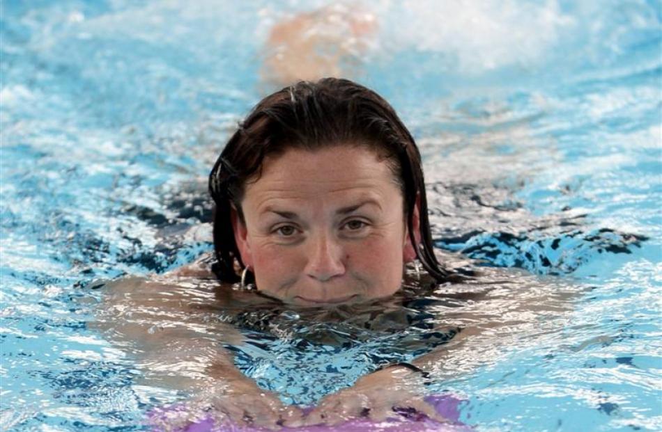 Swimmer Kathy-Jo Dobson uses a flutter-board while putting in a few lengths at the Physio Pool.