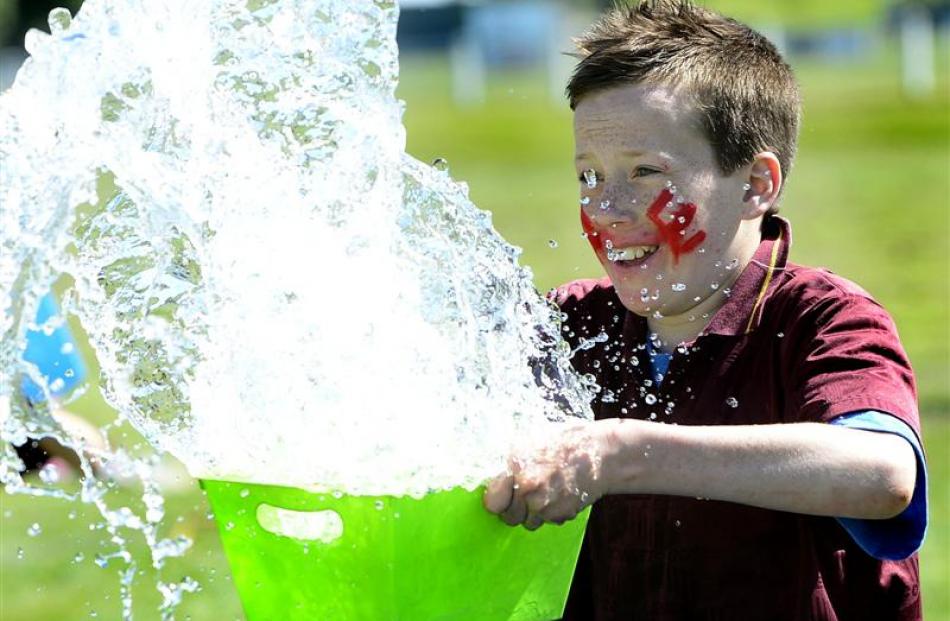 Liam Homer (11), of Waitahuna School, gets wet during the  holey bucket fill