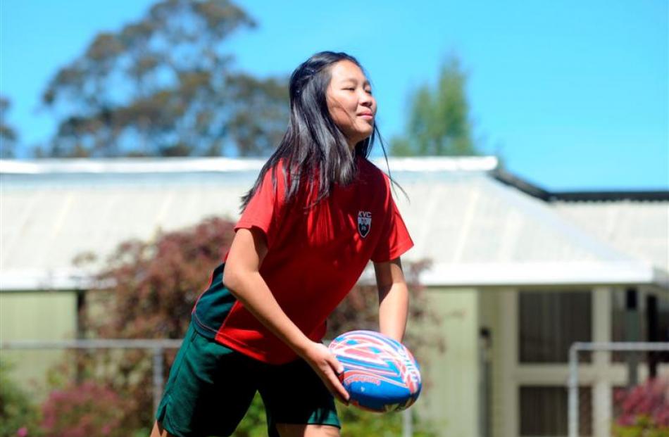 Cindy Luan (13) passes a rugby ball at Kaikorai Valley College yesterday. Photos by Gregor...