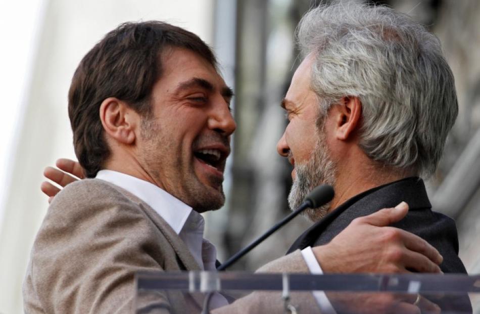 Actor Javier Bardem (L) and director Sam Mendes embrace during a ceremony honouring the actor...