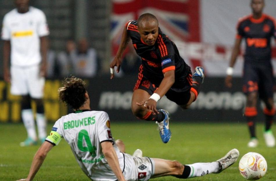 Olympique Marseille's Andre Ayew (R) challenges Borussia Monchengladbach's Roel Brouwers during...